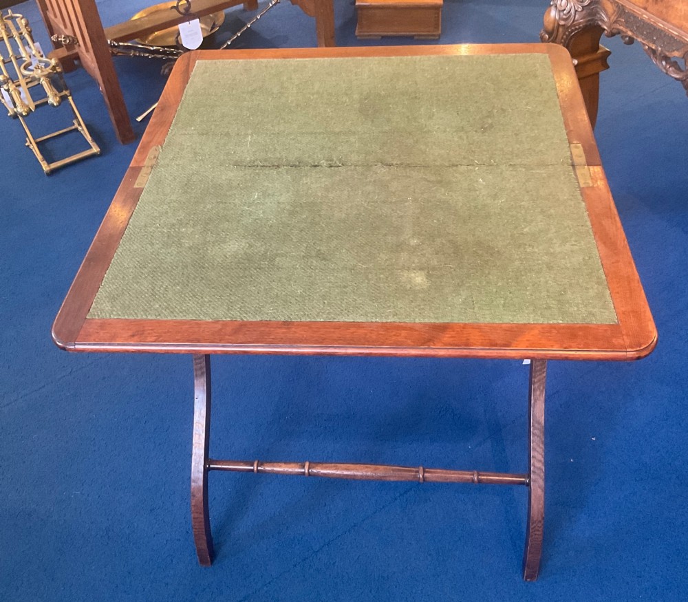 Victorian mahogany folding coaching table featuring a square green baize inset top and turned X-frame legs. View II