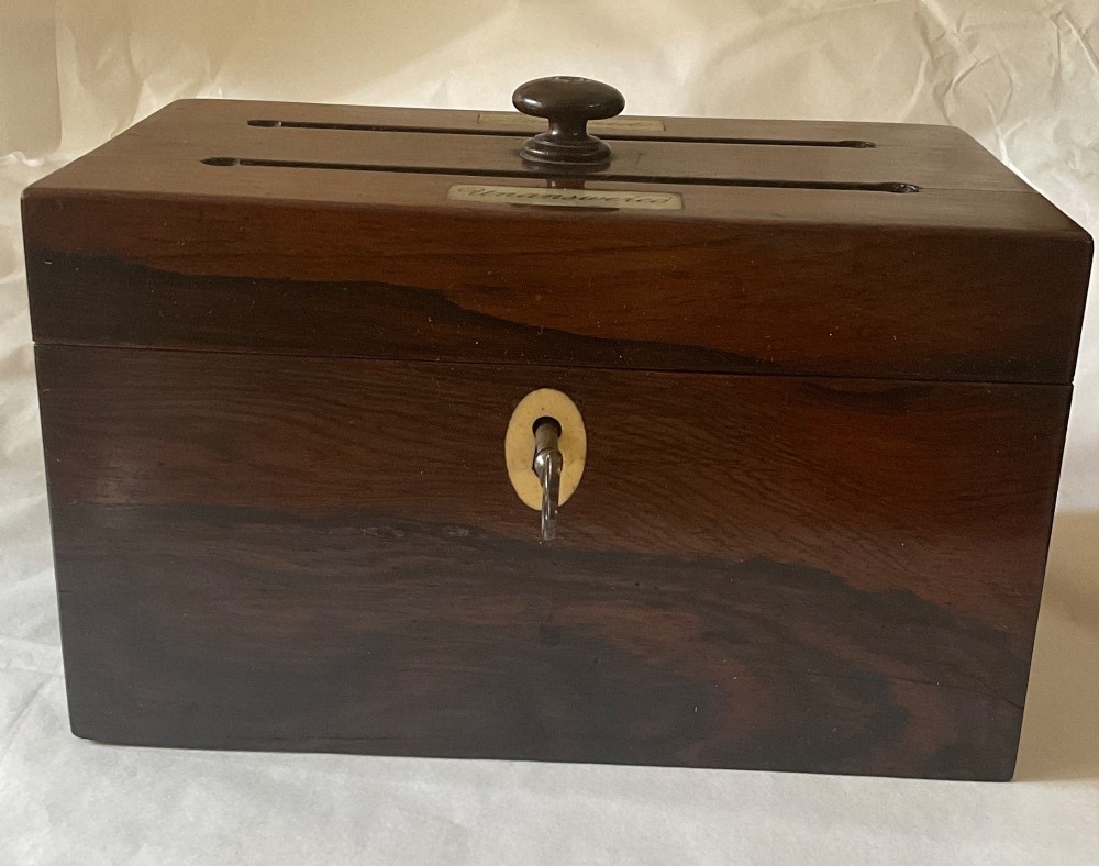 A dark mahogany 19th-century letter box featuring two top slots labelled Answered and Unanswered, a turned central knob, and a front keyhole with an inserted key. View II