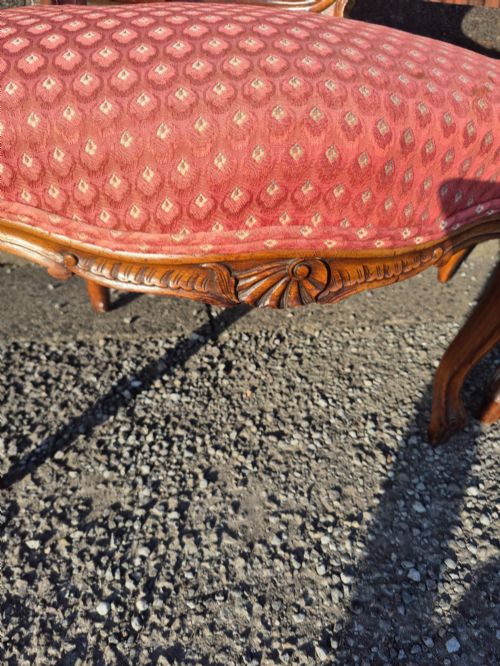 fig 3. A pair of French carved walnut armchairs upholstered in patterned red fabric with cabriole legs and scrolled cresting.