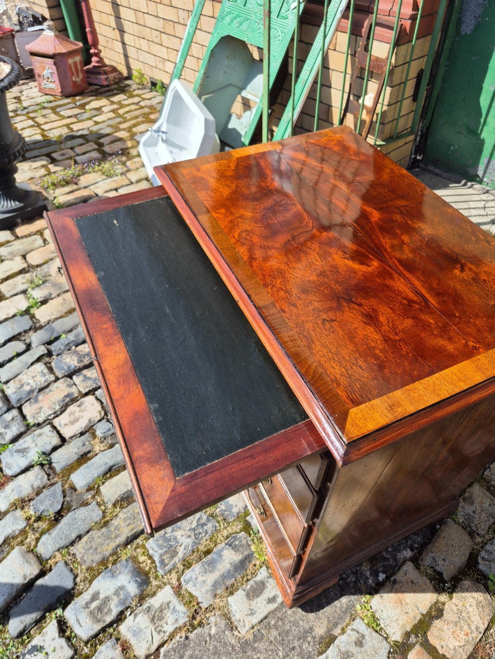 An 18th-century Georgian walnut bachelors chest featuring a brushing slide, four graduated drawers with brass handles, and bracket feet. View X