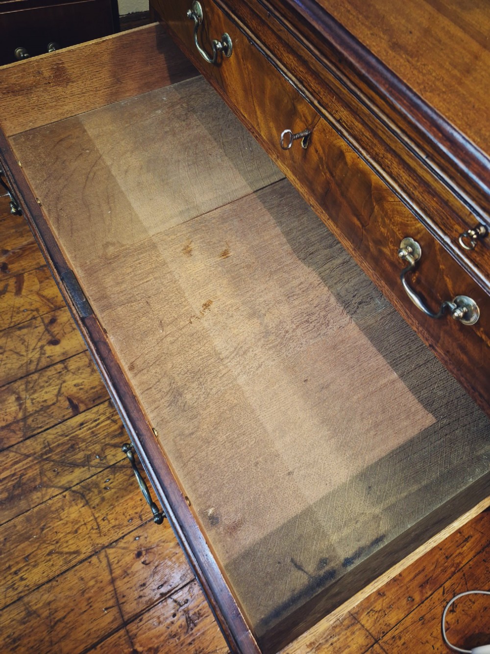 A Georgian mahogany bachelors chest featuring a top brushing slide, four graduated drawers with flame mahogany veneers, brass swan-neck handles, and bracket feet. View VIII