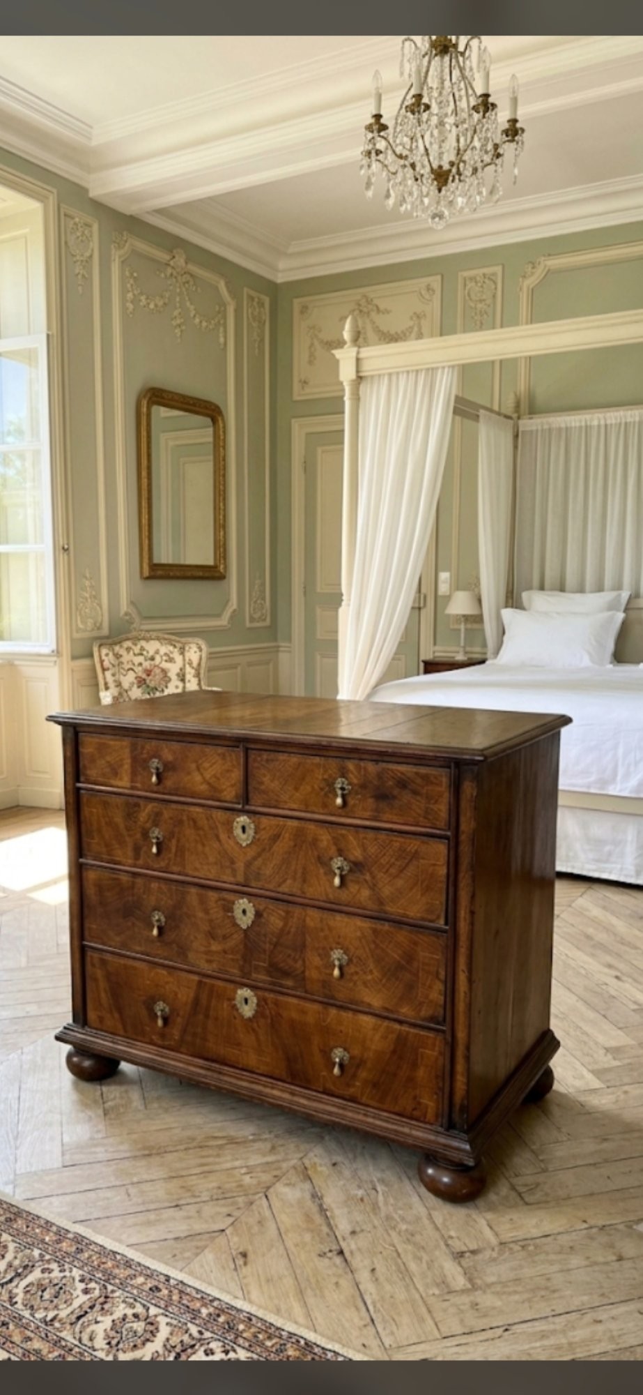 A William and Mary walnut chest of drawers featuring geometric crossbanded drawer fronts, brass drop handles, and compressed bun feet. View II