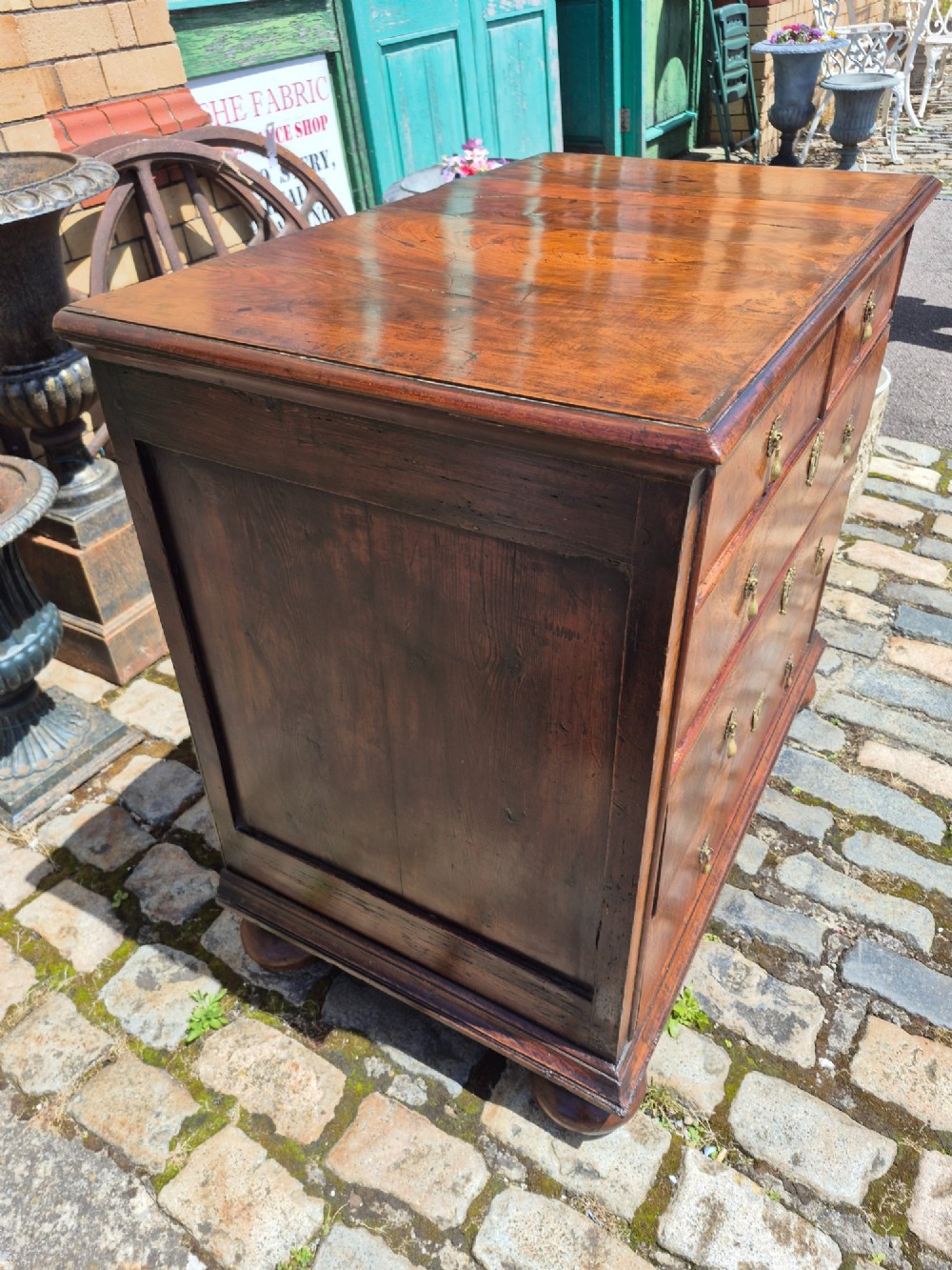 A William and Mary walnut chest of drawers featuring geometric crossbanded drawer fronts, brass drop handles, and compressed bun feet. View VIII