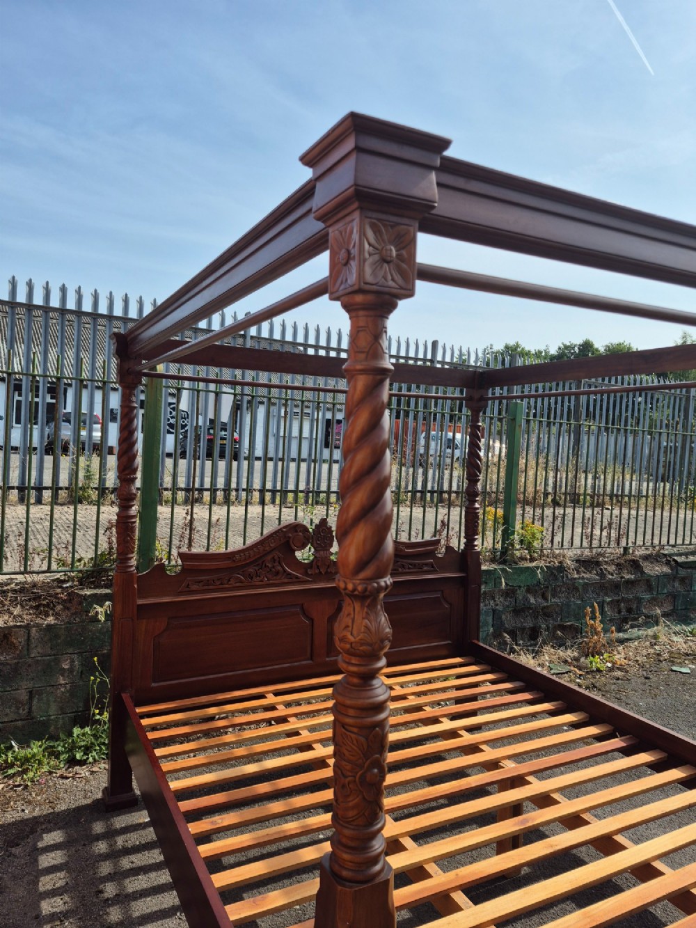 A super king size four-poster bed frame crafted from dark carved wood featuring spiral twisted posts and a scrolled headboard crest. View II