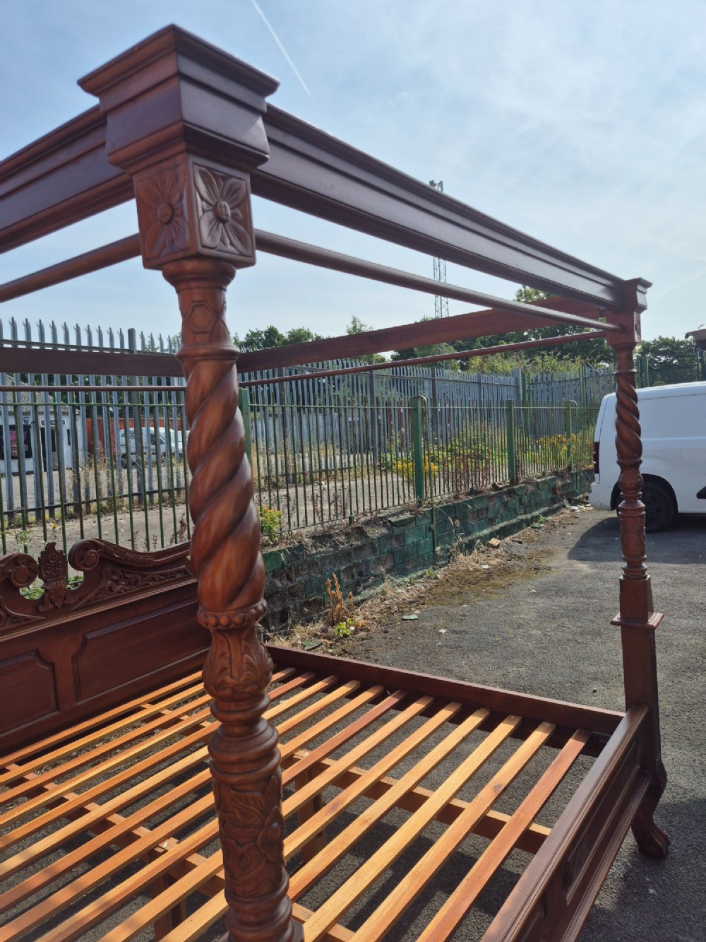 A super king size four-poster bed frame crafted from dark carved wood featuring spiral twisted posts and a scrolled headboard crest. View V