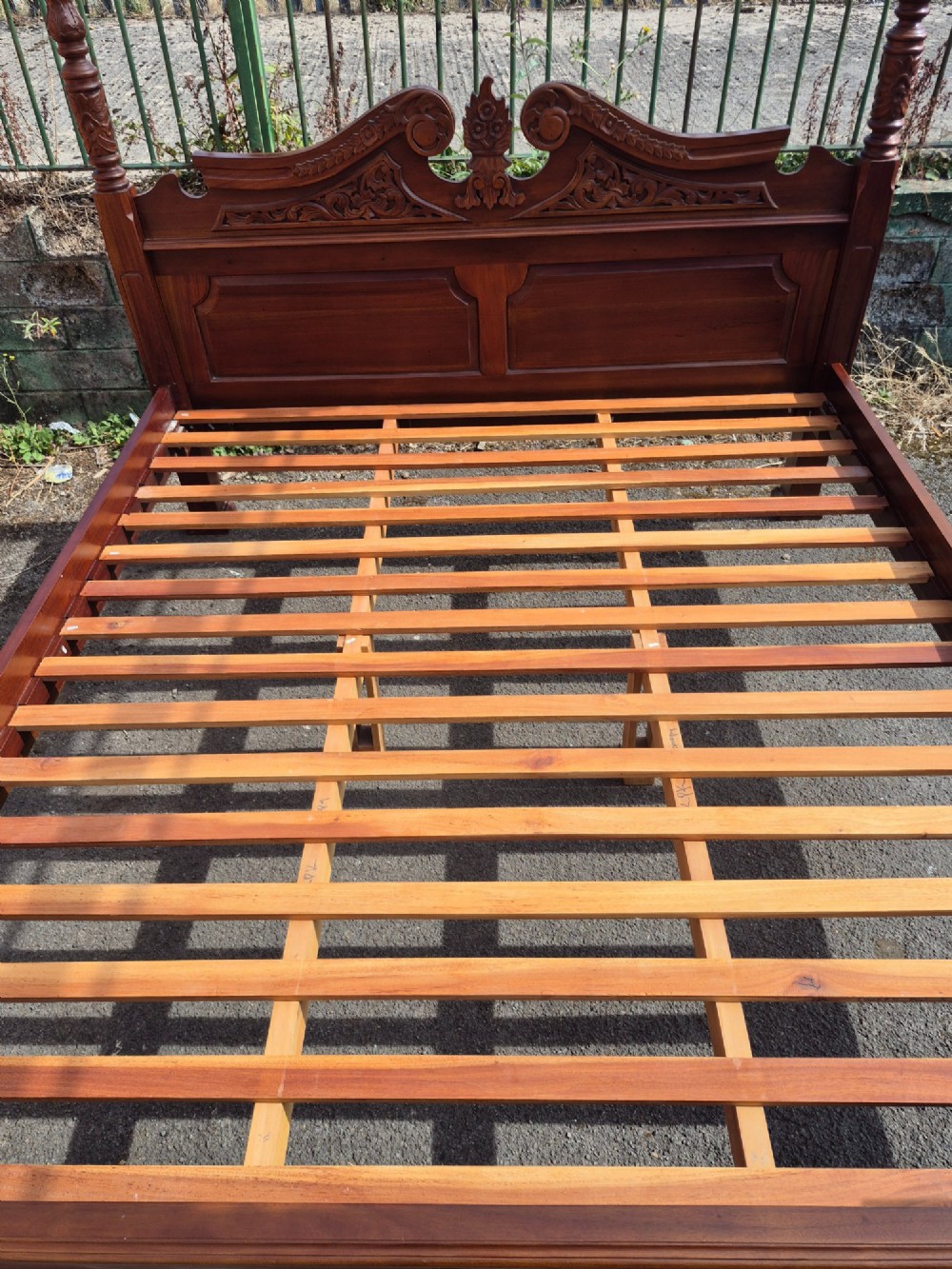 A super king size four-poster bed frame crafted from dark carved wood featuring spiral twisted posts and a scrolled headboard crest. View X
