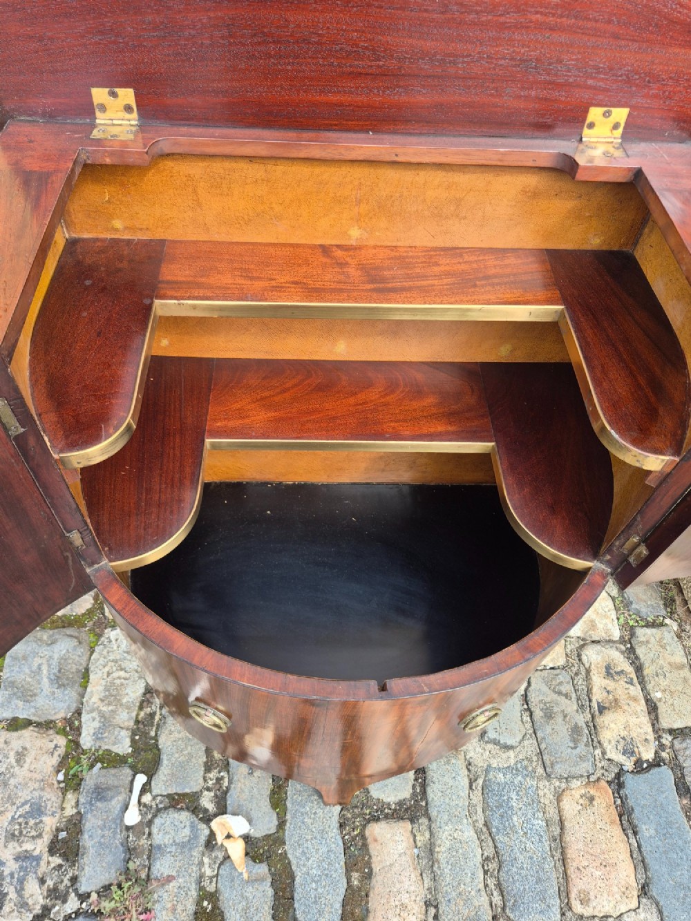 A small semi-circular mahogany cocktail cabinet featuring flame veneer panels and circular brass patera handles. View III