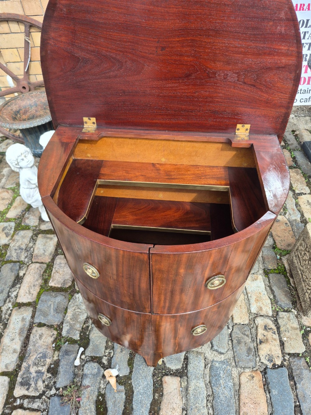 A small semi-circular mahogany cocktail cabinet featuring flame veneer panels and circular brass patera handles. View V