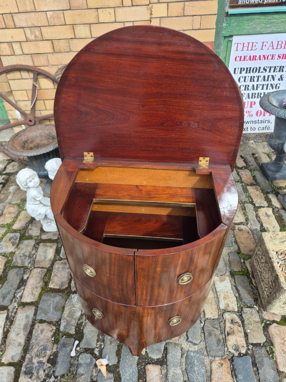 A small semi-circular mahogany cocktail cabinet featuring flame veneer panels and circular brass patera handles. View VI