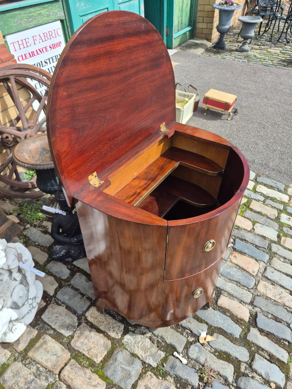 A small semi-circular mahogany cocktail cabinet featuring flame veneer panels and circular brass patera handles. View VIII