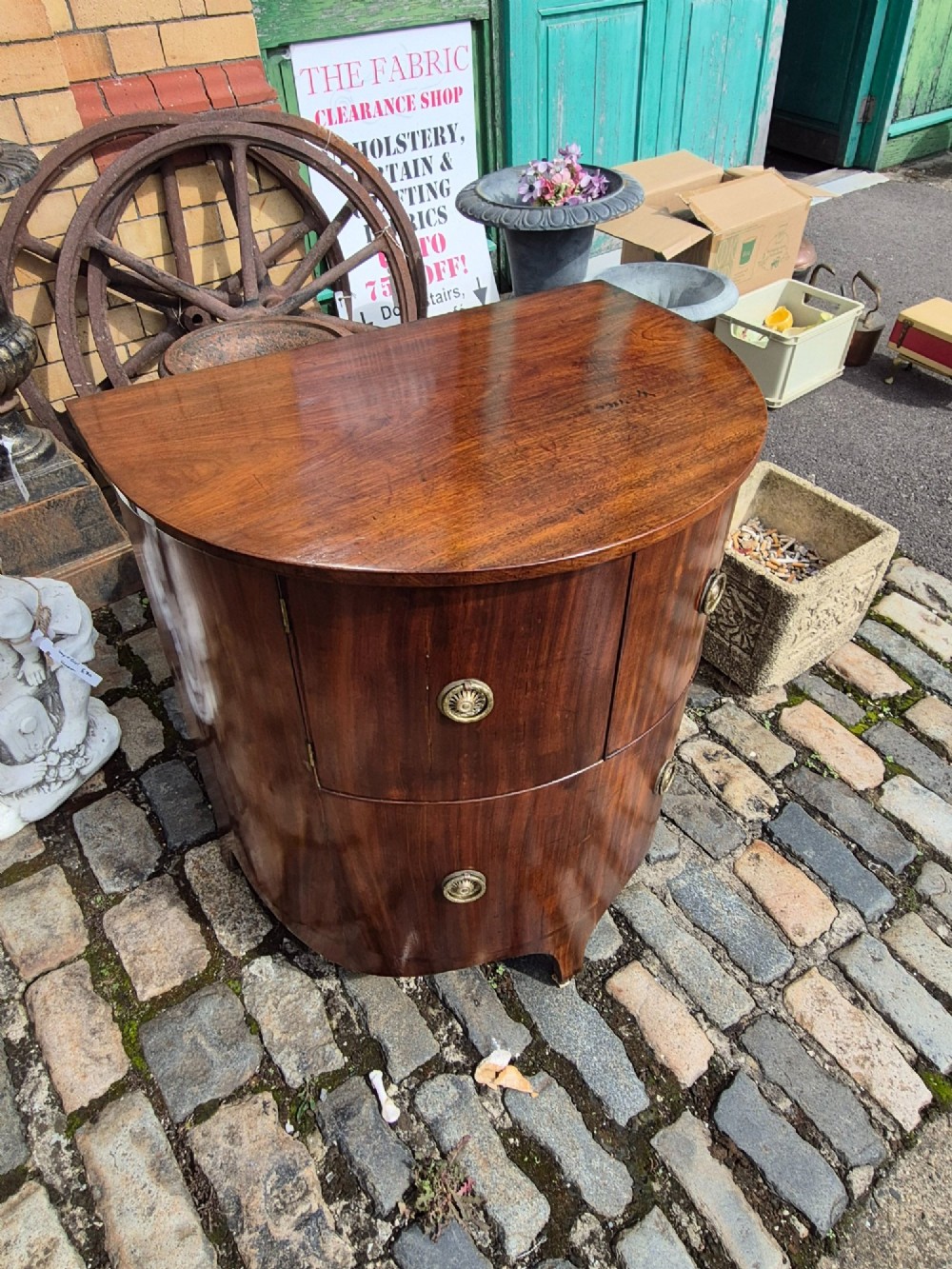 A small semi-circular mahogany cocktail cabinet featuring flame veneer panels and circular brass patera handles. View XI
