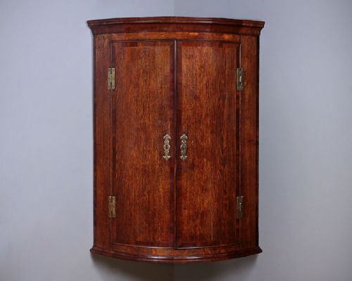 George III Oak Bow Front Corner Cupboard C.1810.