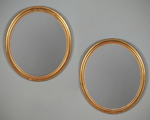 Pair of Large Gilded Oval Wall Mirrors C.1890.