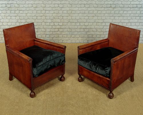 PAIR OF SMALL LEATHER BOTHY ARMCHAIRS C1920