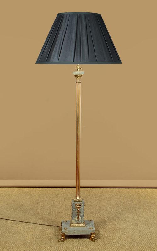 An adjustable French Empire style brass floor lamp featuring a fluted standard column set upon a grey marble base with brass claw feet. View II