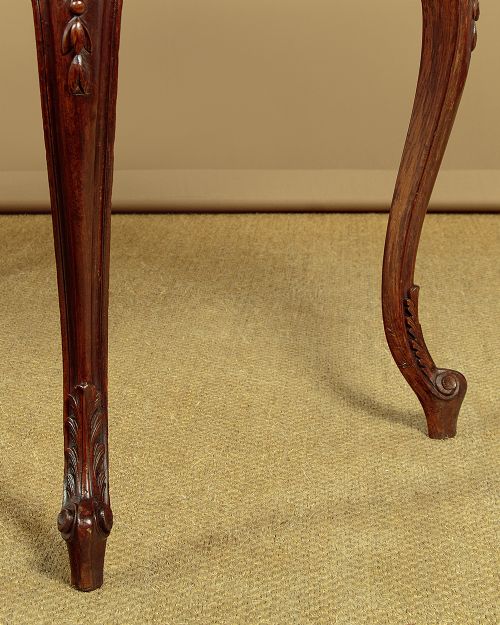 A late nineteenth-century carved walnut centre table with cabriole legs, Rococo frieze carving, and a rouge marble top. View VIII