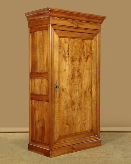 A single-door antique French Louis Philippe cherrywood wardrobe with figured timber grain and a moulded cornice. View II