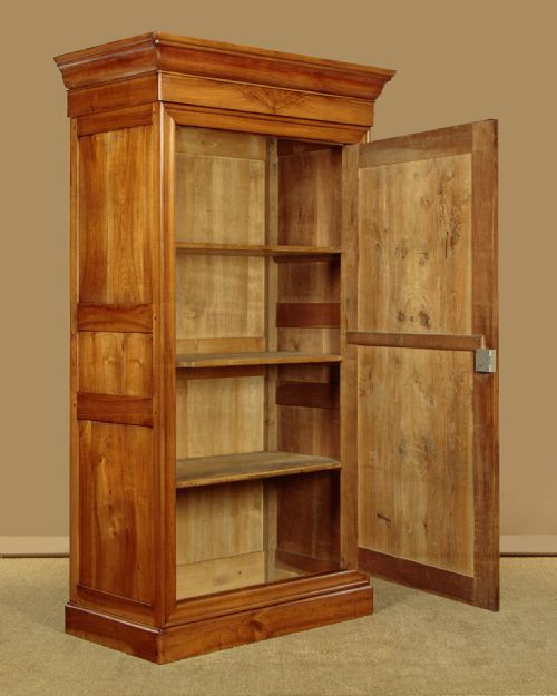 A single-door antique French Louis Philippe cherrywood wardrobe with figured timber grain and a moulded cornice. View IV