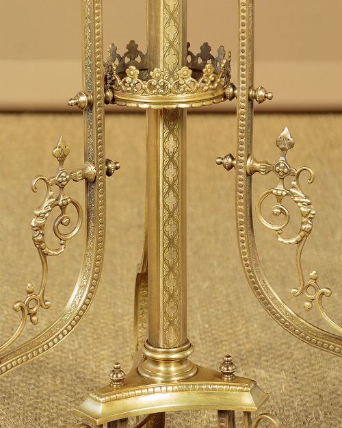 An Edwardian brass standard lamp featuring an integrated circular onyx wine table with a pierced gallery trim atop a scrolling tripod base. View VIII