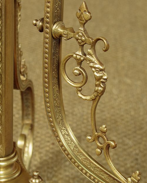 An Edwardian brass standard lamp featuring an integrated circular onyx wine table with a pierced gallery trim atop a scrolling tripod base. View X