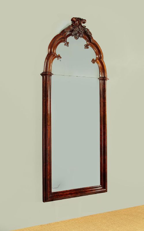 A tall and narrow 19th-century dark mahogany pier mirror featuring a carved Gothic arch cresting and moulded side pillars. View II