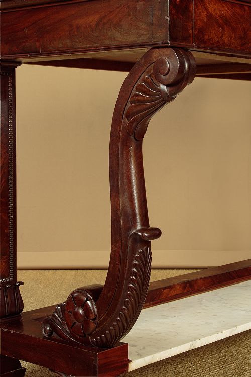 A 19th-century mahogany console table with a white marble top, lower marble tier, carved scroll legs, and paw feet. View VIII
