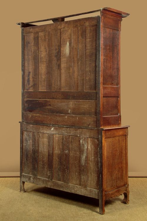 An 18th-century French provincial oak housekeepers cupboard featuring two upper and two lower moulded panel doors with carved star motifs and cabriole feet. View XIV