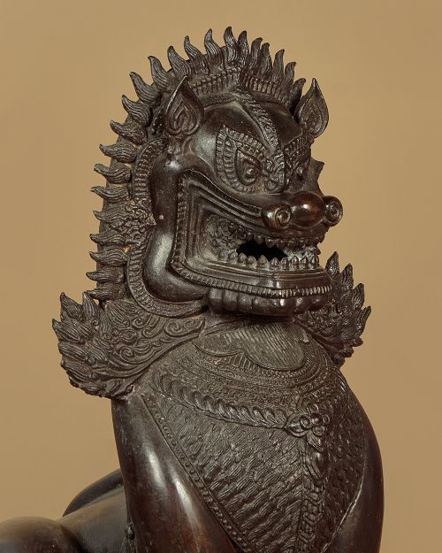 A pair of dark bronze temple lion statues sitting upright with intricate stylized manes and detailed ornamental chest bands. View V