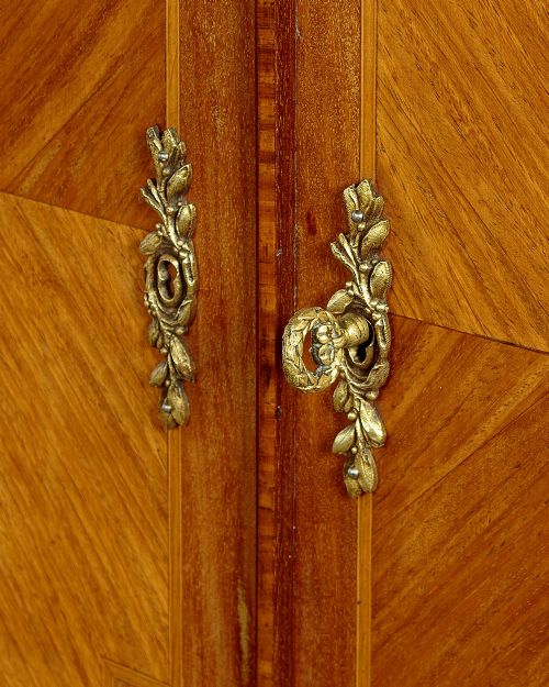 A tall Louis XVI style wooden side cabinet featuring geometric herringbone parquetry veneers, brass mounts, and a polished marble top. View IX