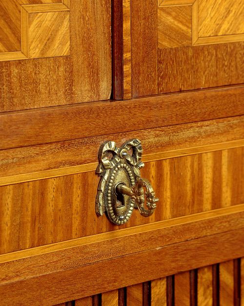 A tall Louis XVI style wooden side cabinet featuring geometric herringbone parquetry veneers, brass mounts, and a polished marble top. View XI