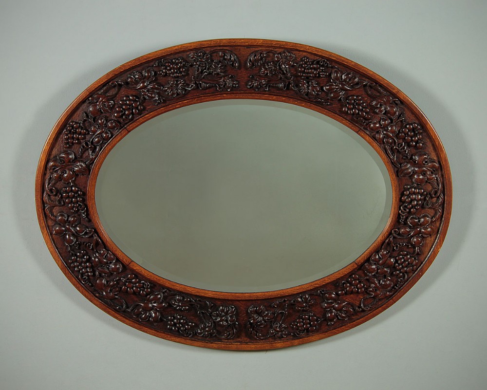 Oval Carved Oak Wall Mirror c.1910.