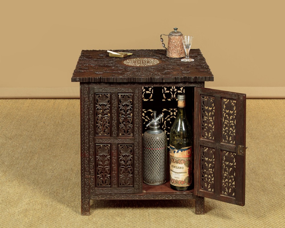 A dark wood square Anglo-Indian side table decorated with reticulated foliate carving on all panels and a circular bone inlay detail in the centre top. View II