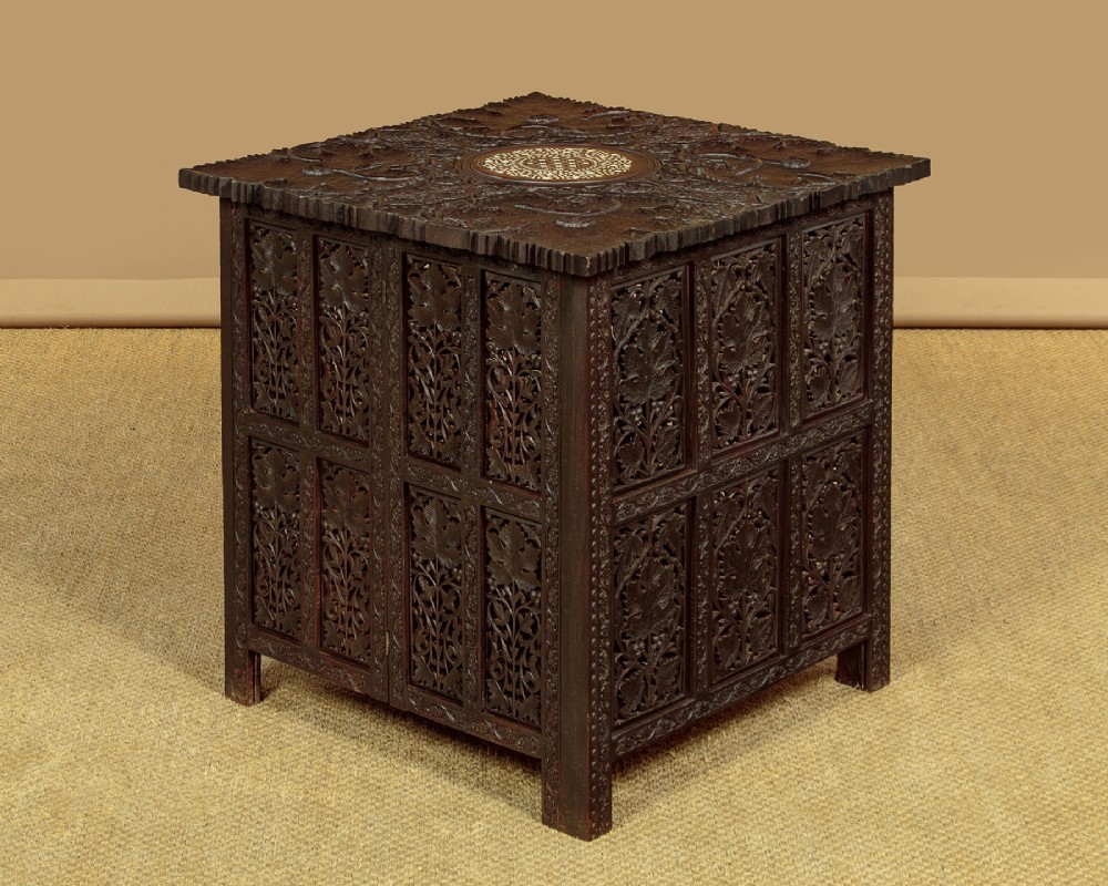 A dark wood square Anglo-Indian side table decorated with reticulated foliate carving on all panels and a circular bone inlay detail in the centre top.