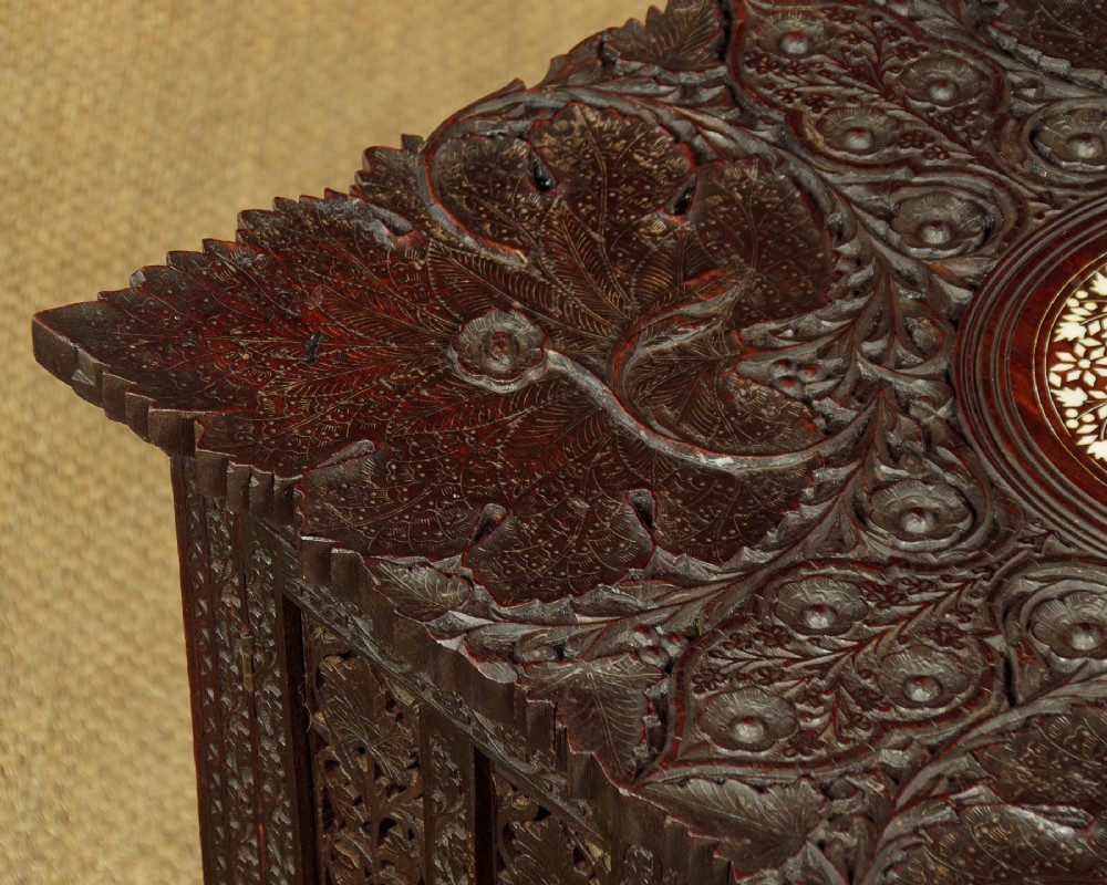 A dark wood square Anglo-Indian side table decorated with reticulated foliate carving on all panels and a circular bone inlay detail in the centre top. View X