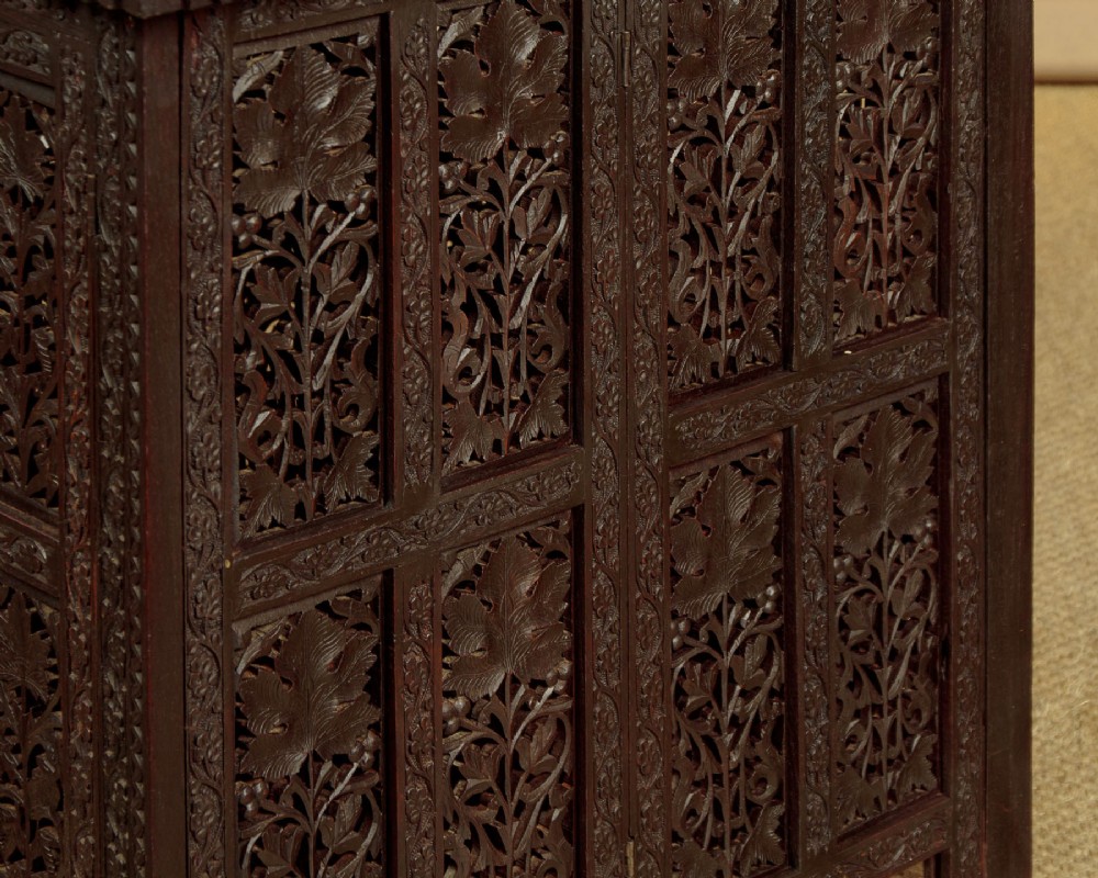 A dark wood square Anglo-Indian side table decorated with reticulated foliate carving on all panels and a circular bone inlay detail in the centre top. View XI