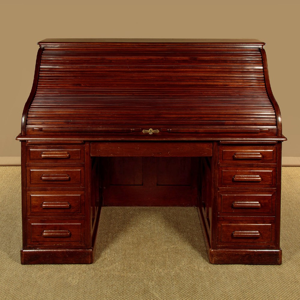 An Edwardian dark walnut roll top desk with a open slatted tambour shutter revealing interior drawers and pigeonholes above twin pedestal bases. View III