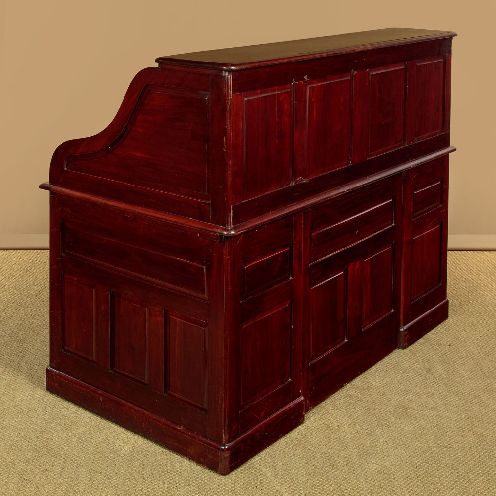 An Edwardian dark walnut roll top desk with a open slatted tambour shutter revealing interior drawers and pigeonholes above twin pedestal bases. View XIII