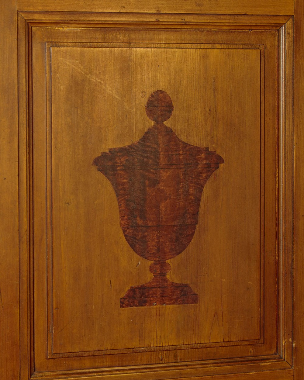 A single-door pine wardrobe featuring hand-painted urn motifs on two panelled sections and a dated inscription near the moulded cornice. View VI
