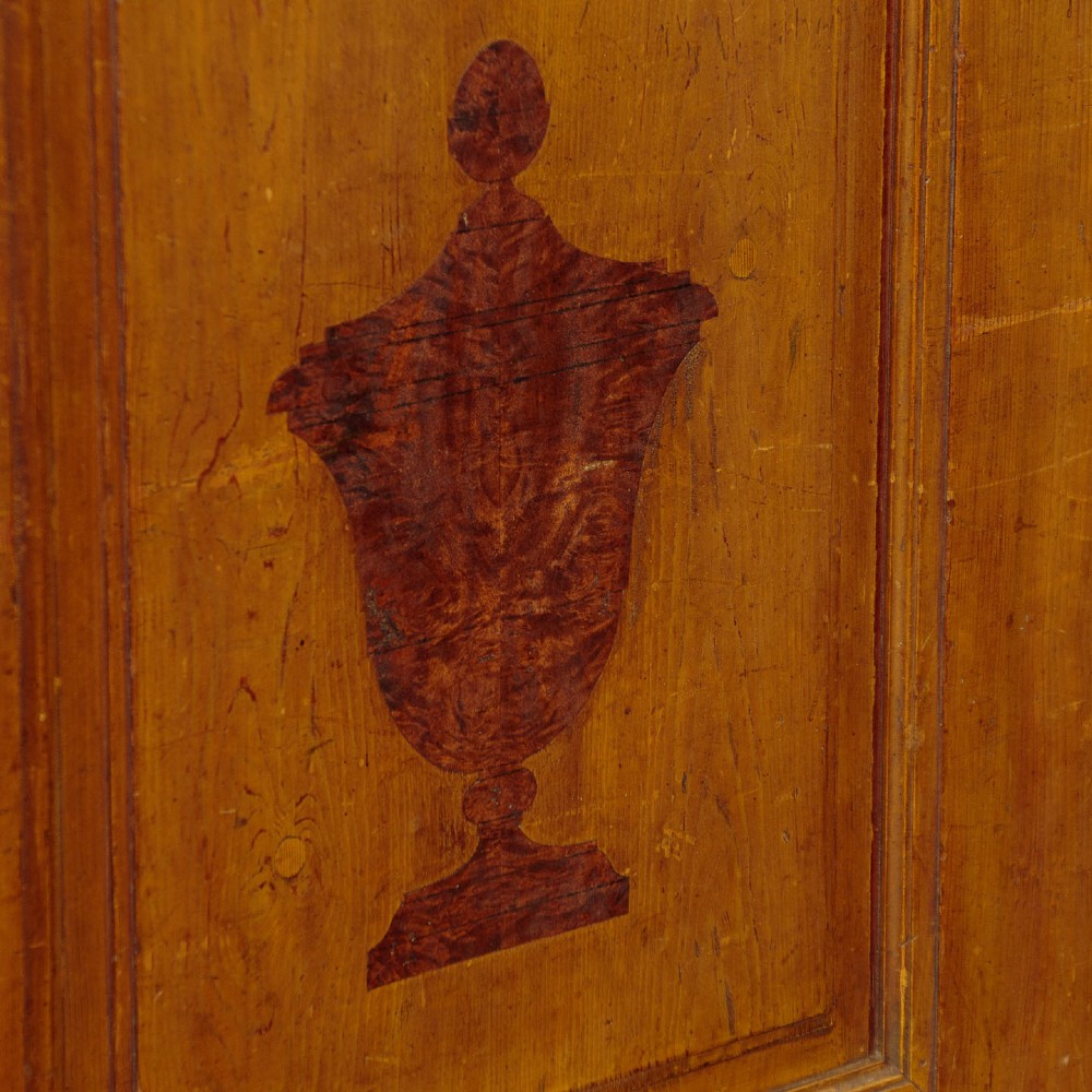 A single-door pine wardrobe featuring hand-painted urn motifs on two panelled sections and a dated inscription near the moulded cornice. View VIII