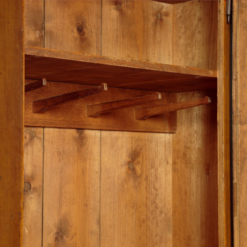 A single-door pine wardrobe featuring hand-painted urn motifs on two panelled sections and a dated inscription near the moulded cornice. View X