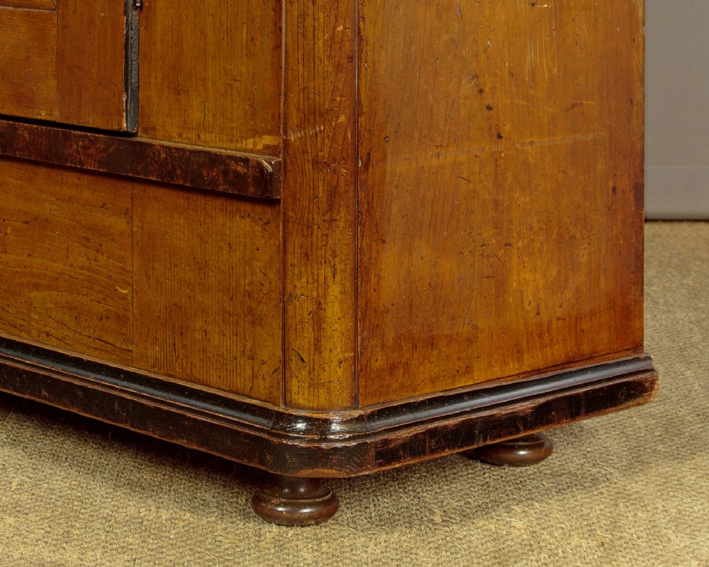 A single-door pine wardrobe featuring hand-painted urn motifs on two panelled sections and a dated inscription near the moulded cornice. View XII