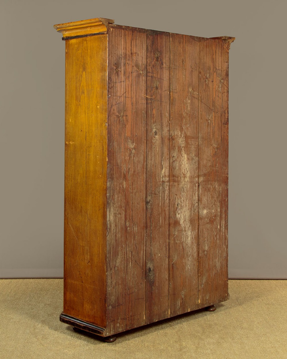 A single-door pine wardrobe featuring hand-painted urn motifs on two panelled sections and a dated inscription near the moulded cornice. View XIV