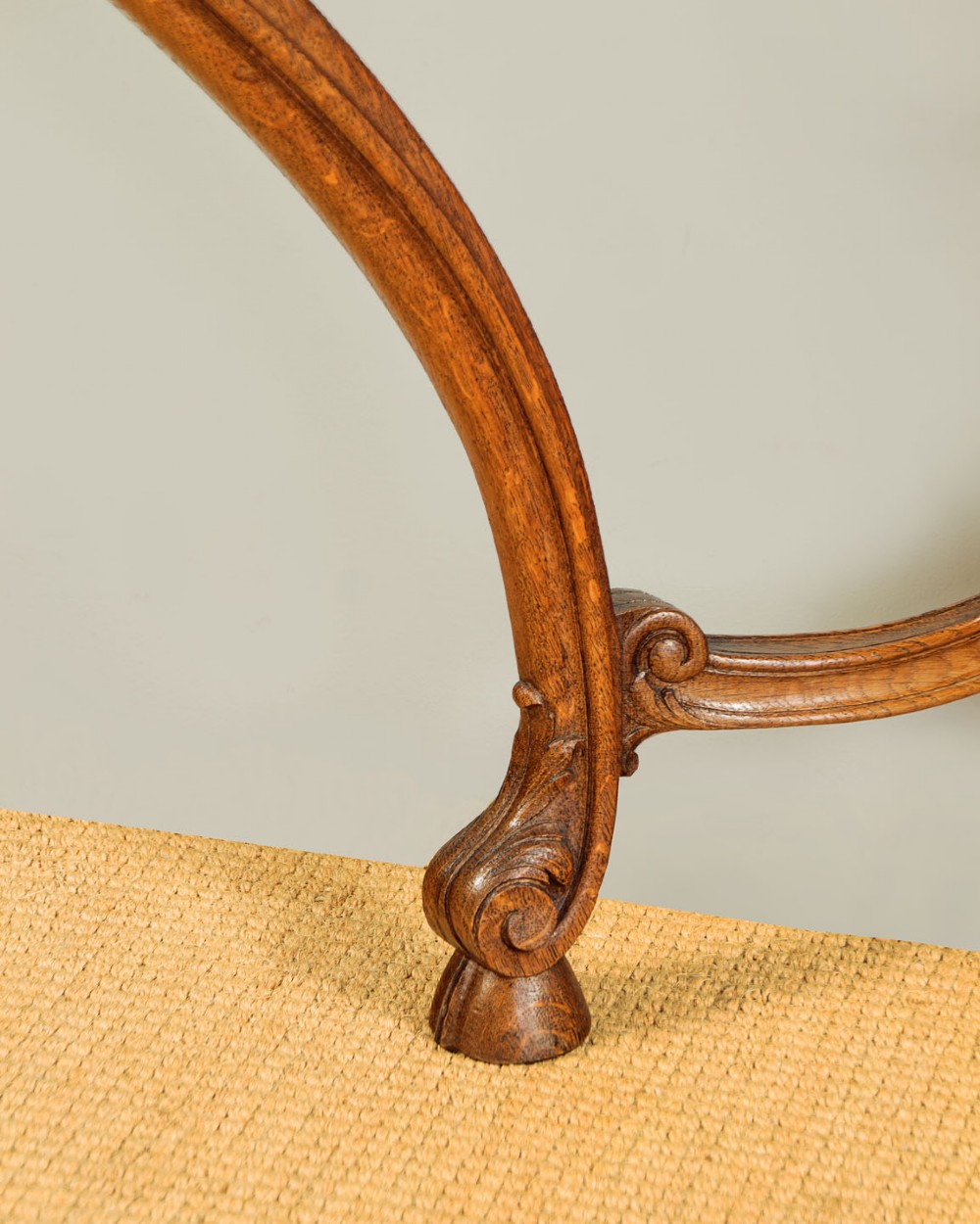 An oak console table featuring a shaped grey marble top, floral relief carvings along the apron, exaggerated cabriole legs, and a scrolled stretcher. View IX