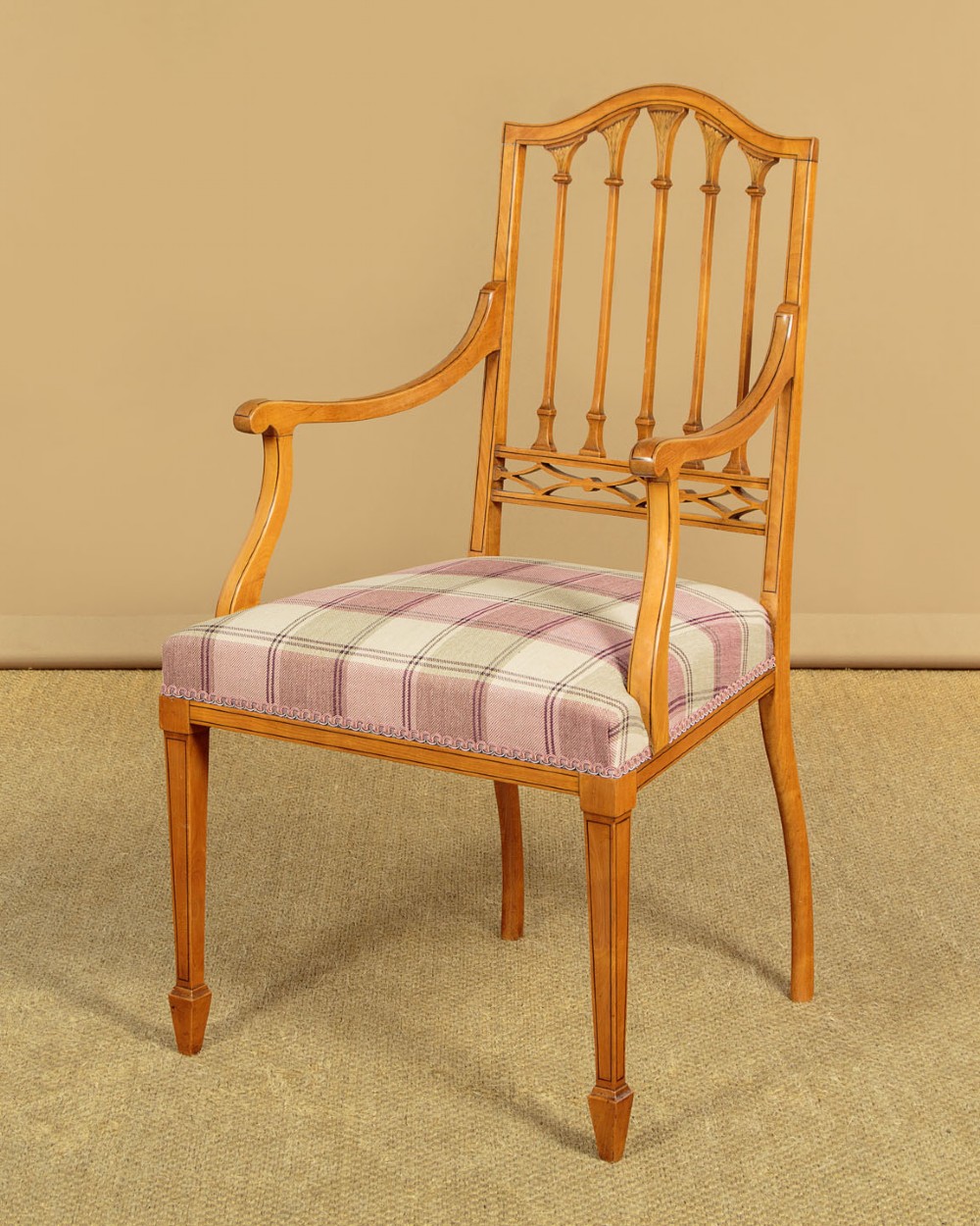 A pair of inlaid satinwood armchairs featuring arched spindle backrests and pink plaid upholstered seats. View IV