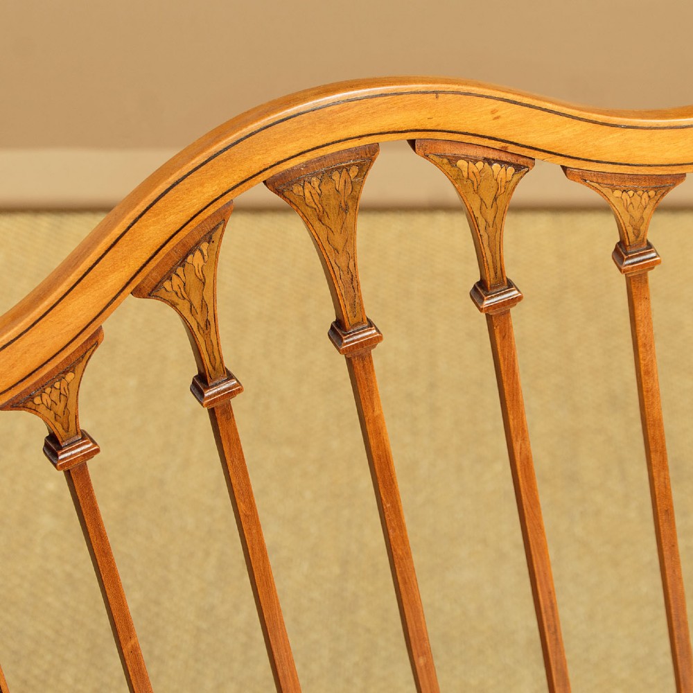 A pair of inlaid satinwood armchairs featuring arched spindle backrests and pink plaid upholstered seats. View VI