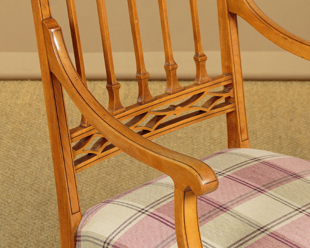 A pair of inlaid satinwood armchairs featuring arched spindle backrests and pink plaid upholstered seats. View VII