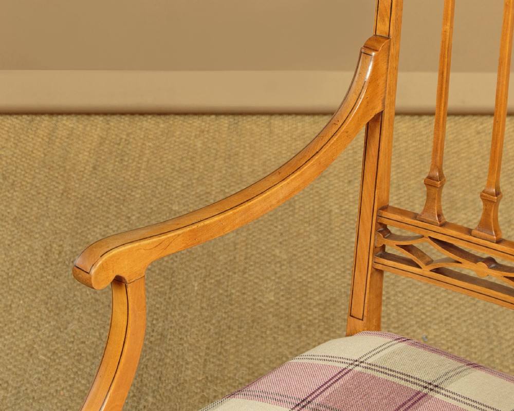 A pair of inlaid satinwood armchairs featuring arched spindle backrests and pink plaid upholstered seats. View VIII