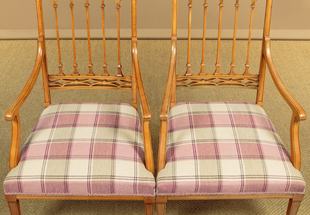 A pair of inlaid satinwood armchairs featuring arched spindle backrests and pink plaid upholstered seats. View IX