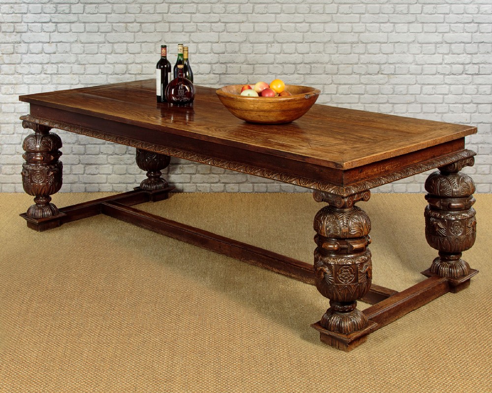 A large dark oak refectory dining table featuring heavily carved bulbous turned legs, an ornate frieze, and low stretchers. View III