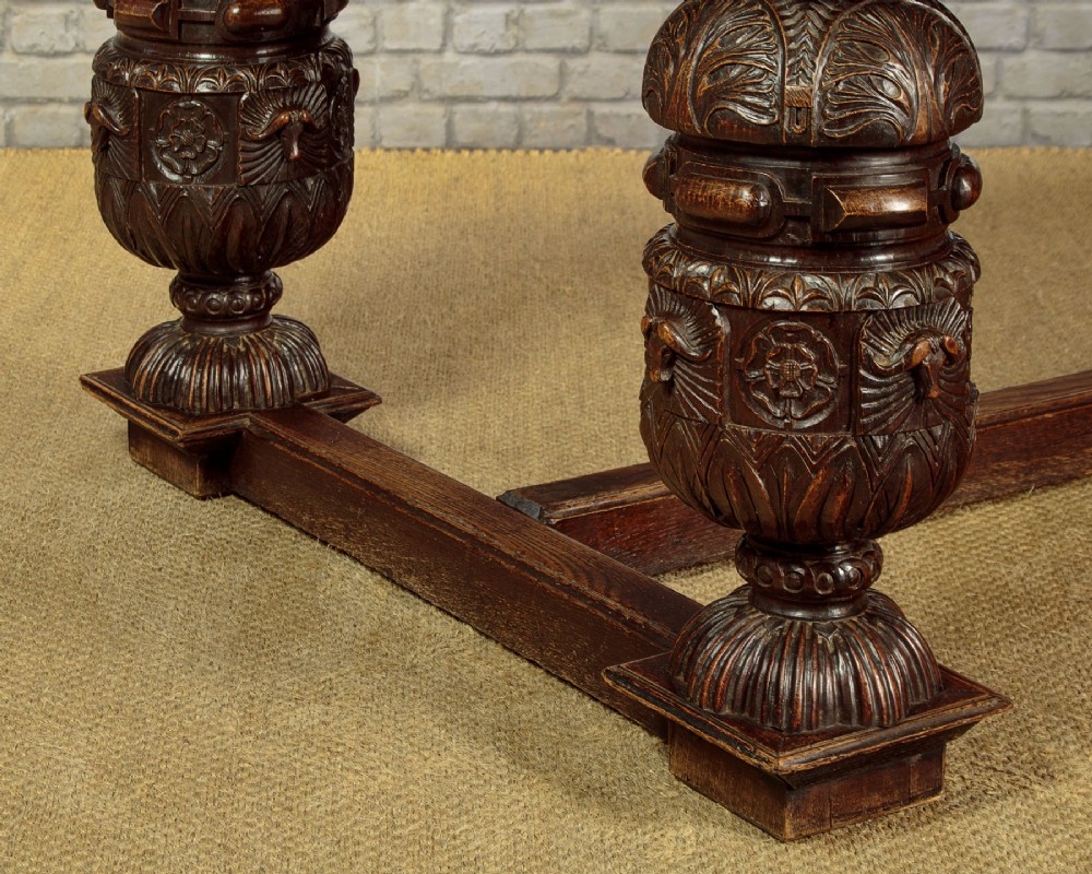 A large dark oak refectory dining table featuring heavily carved bulbous turned legs, an ornate frieze, and low stretchers. View VIII
